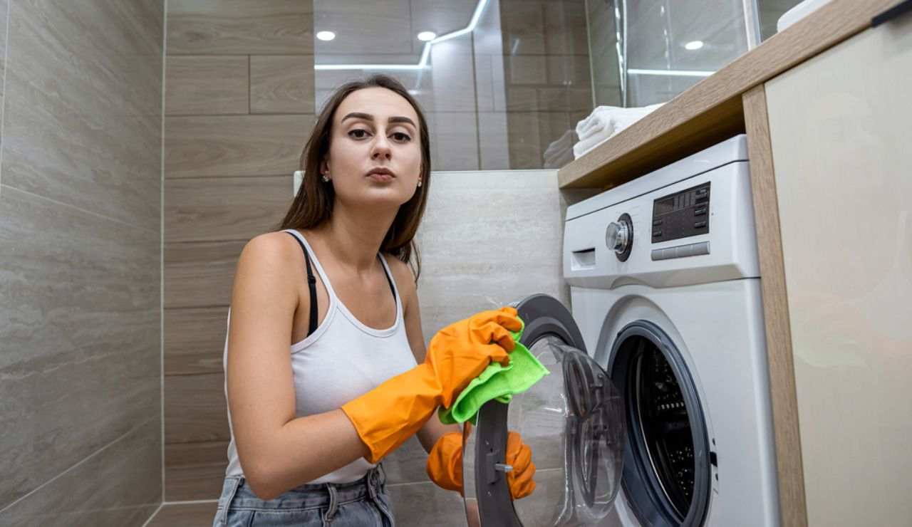 Donna asciuga oblò della lavatrice